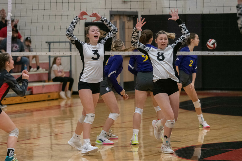 Toledo's Ellie Fallon (3) and Jordynne Hensley (8) celebrate a point during the first set of the Riverhawks' five-set win over Onalaska on Oct. 25.
