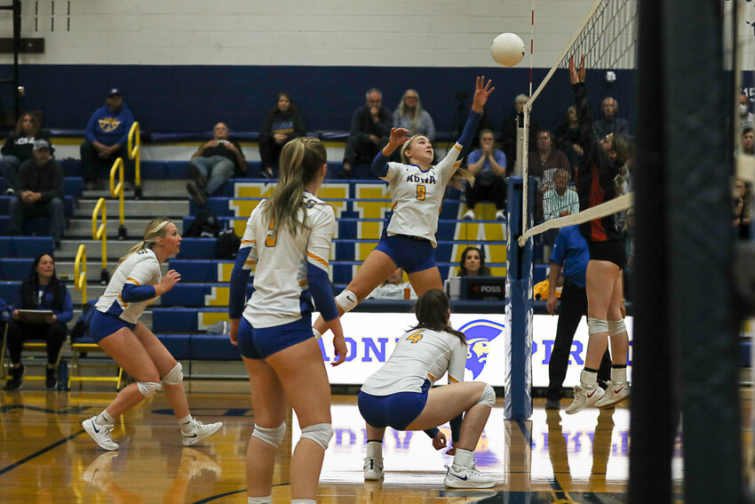 Danika Hallom tips the ball over the net and a leaping Toledo defender during Adna's 2B District 4 quarterfinal victory vs. Toledo on Oct. 28.