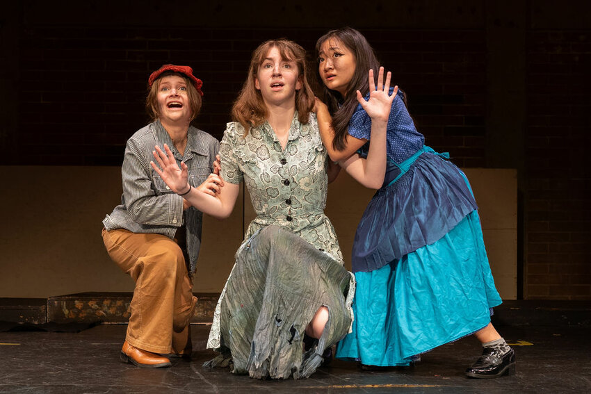 Molly Brennan (left), Emalyn Pierce (center) and Valyssa Nguyen rehearse for Prairie High School drama&rsquo;s production of Urinetown the Musical.