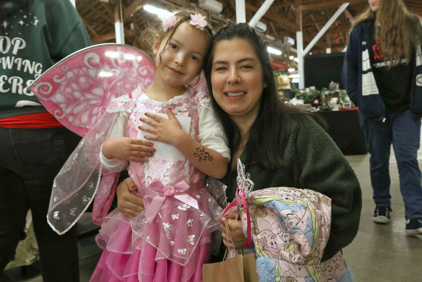 Mila, 5, and Terra Watson smile for a photo during the All Hallows Fantasy Festival at the Southwest Washington Fairgrounds in Centralia on Saturday, Oct. 28.