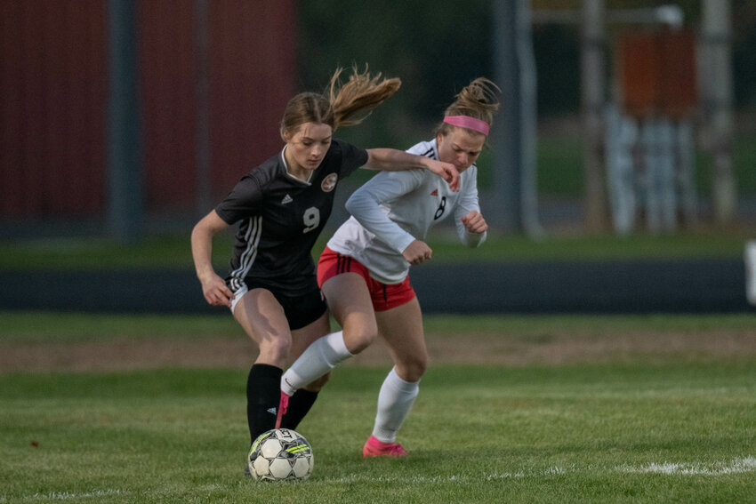 Napavine's Hannah Fay battles for possession with Toledo's Peyton Holter during the first half of the Tigers' match against the Riverhawks in the first round of the 2B District 4 tournament on Oct. 30.