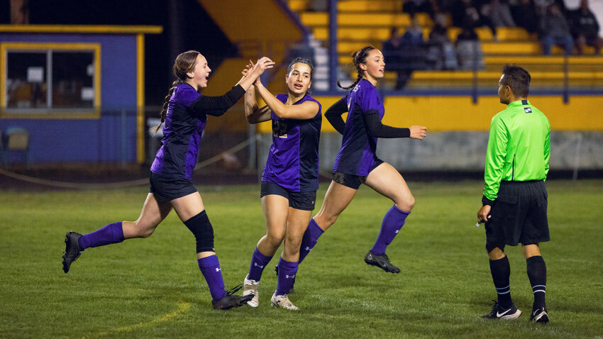 Onalaska&rsquo;s Kaiyah Sandridge (22) celebrates a goal alongside Randi Haight (13), left, and Jules Auman (12), right, during the Loggers' 6-1 win over Ocosta in the first round of the 2B District 4 tournament on Oct. 30 in Onalaska.