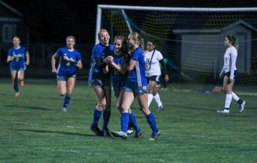 Bailey Naillon (middle) celebrates with Ava Humphrey (left) and Reagan Naillon (right) after scoring a goal in Adna's 2-1 win over RSB in the first round of the 2B District 4 tournament on Oct. 30.