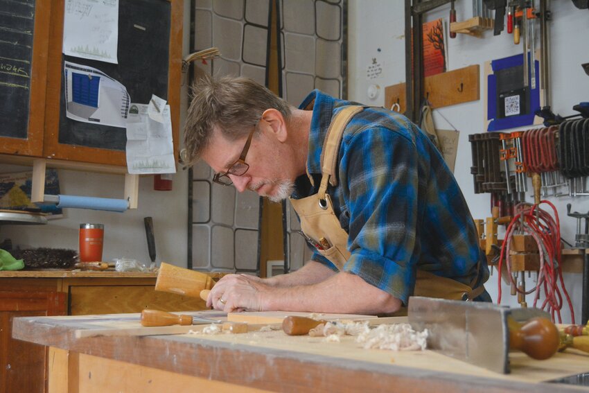 Brian Anderson works on a dovetail in his garage on Oct. 20.