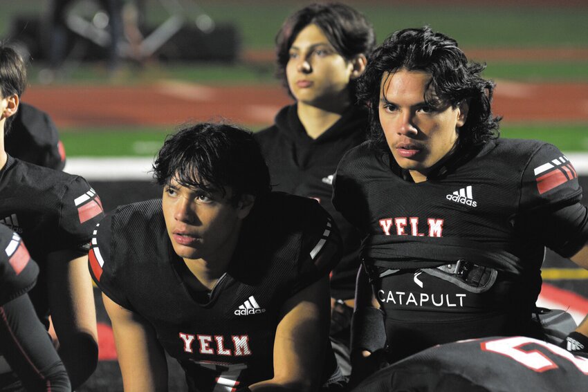 Marius (left) and Damian (right) Aalona listen to a postgame message from head coach Jason Ronquillo after a 59-9 victory over the Peninsula Seahawks, Oct. 20.