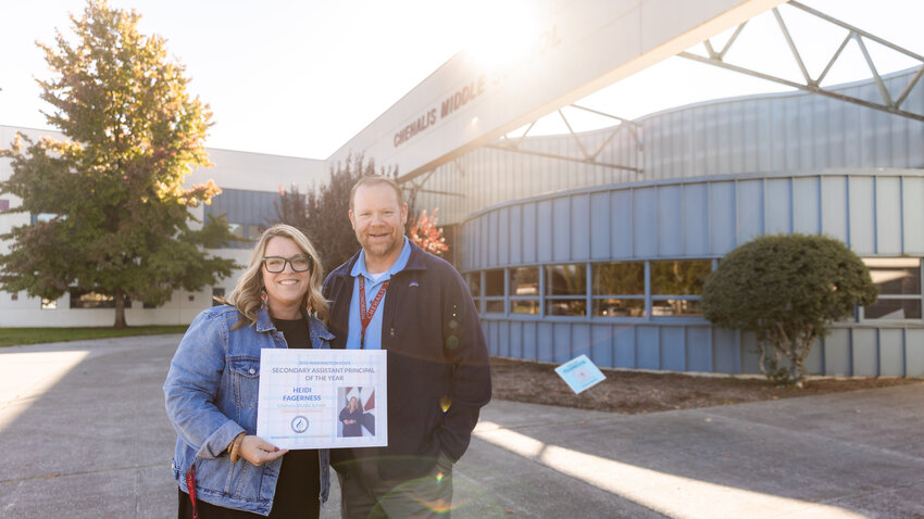 Assistant Principal Heidi Fagerness and Principal Chris Simpson smile for a photo at Chehalis Middle School on Monday after Fagerness was awarded the title of Secondary Assistant Principal of the Year.