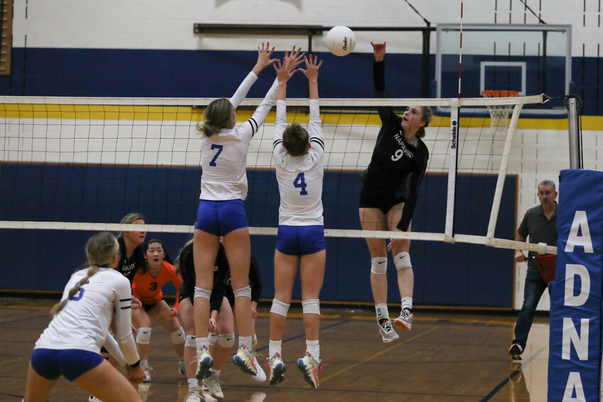Keira O'Neill rises up to spike the ball past two Toutle Lake defenders during Napavine's 3-1 loss to Toutle Lake in a 2B District 4 semifinal on Nov. 1 at Adna.