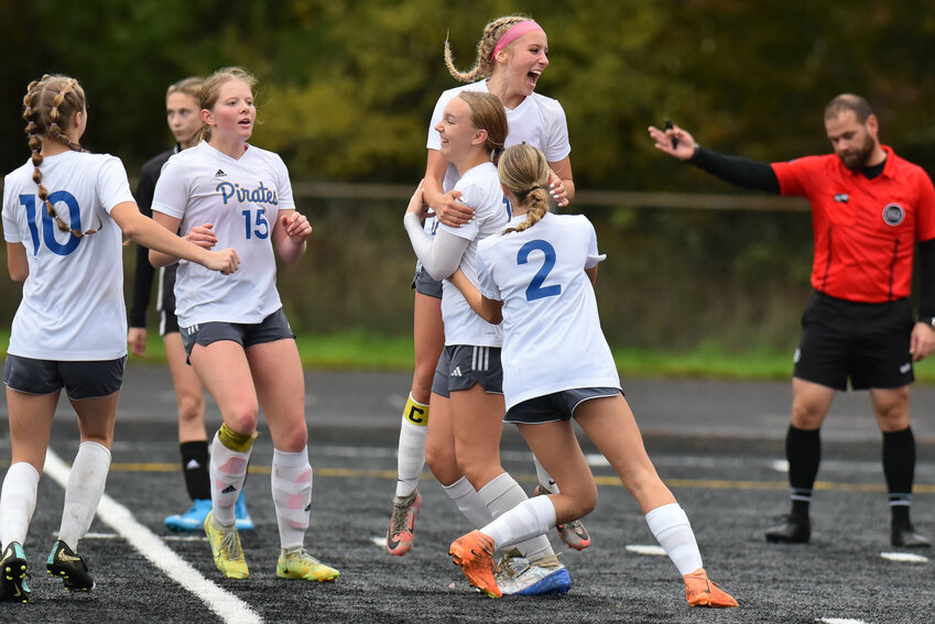 Adna players celebrate with Lilly Wellander after her game winning goal during a 3-2 victory over Napavine Nov. 4.