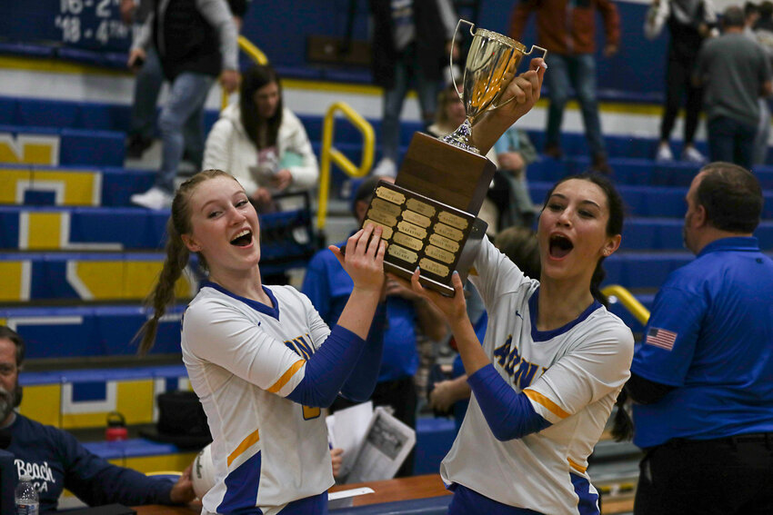 Gaby Guard and Charissa Schierman lift the trophy after the Pirates won the 2B District 4 Championship on Nov. 4.