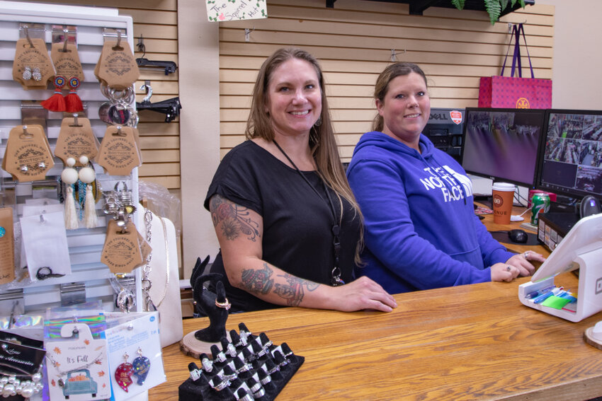 The Squirrel Hut Boutique owner Erica Lewis, left, poses with employee Missy Anno on Oct. 20 in the newly reopened store in Chehalis.