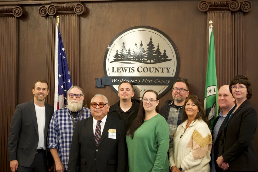The Lewis County commissioners pose with veterans of the United States armed forces who work for Lewis County during a recognition of Veteran's Day at the Commissioner's Nov. 7 business meeting. Pictured from left are Commissioner Sean Swope, Paul Mordick, Ricardo Barrientes, Bradley Clark, Heidi Palmer, Chris Brewer, Tanya Hahn, Commissioner Scott Brummer and Commissioner Lindsey  Pollock.