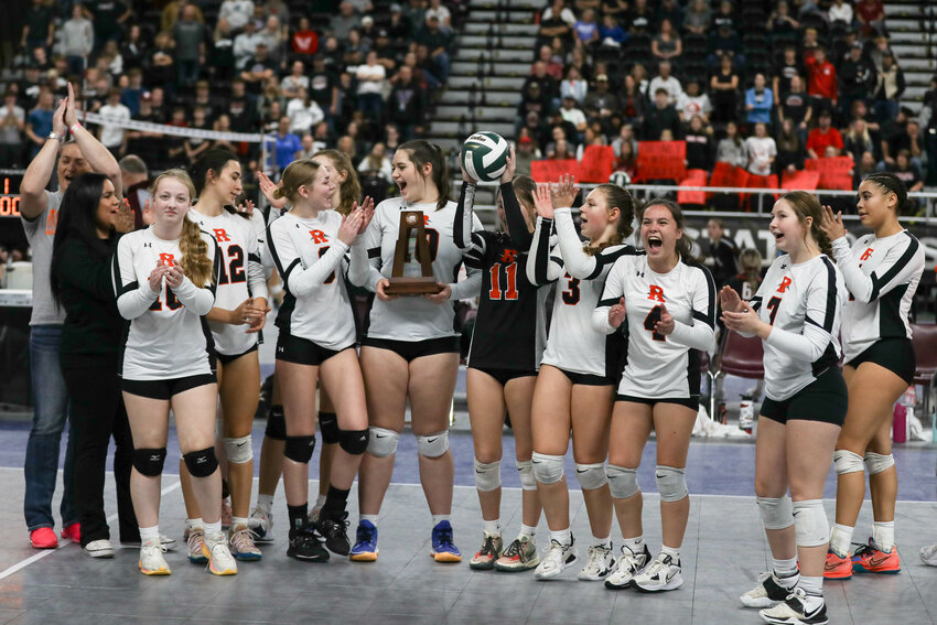 The Mountaineers celebrate with the fourth-place trophy at the end of the state tournament on Nov. 9 in Yakima.