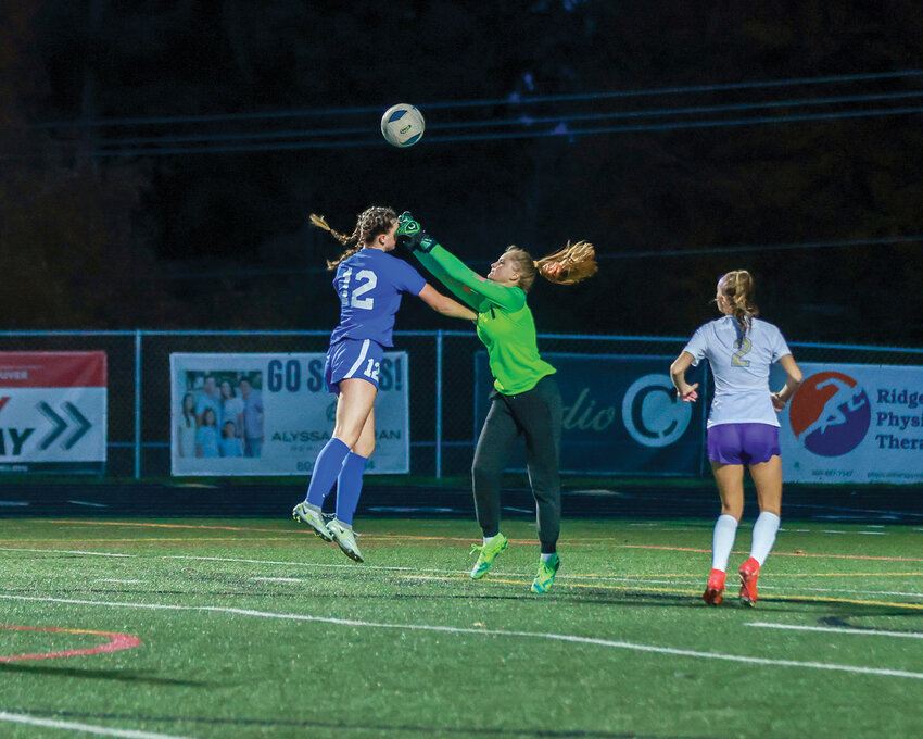 The Ridgefield Spudders&rsquo; Marlee Buffham battles for the ball against the Sequim Wolves&rsquo; goalkeeper in the first round of the 2A state playoffs on Wednesday, Nov. 8.