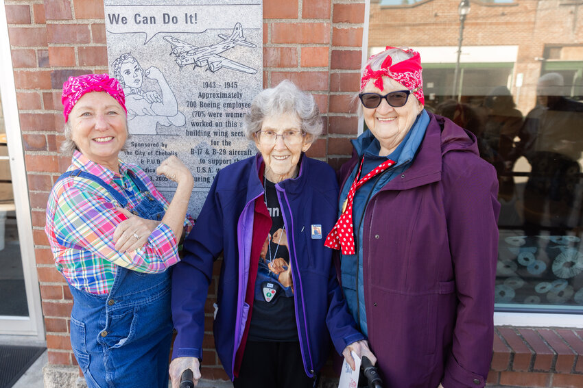 Marie Panesko, Doris Bier and Edna Fund smile for a photo on Thursday in front of a &ldquo;Rosie The Riveter&rdquo; plaque honoring Boeing employees who crafted wing sections for the B-17 and B-29 aircraft during World War II. The plaque is on display in Chehalis outside the Lewis County Public Utility District building.
