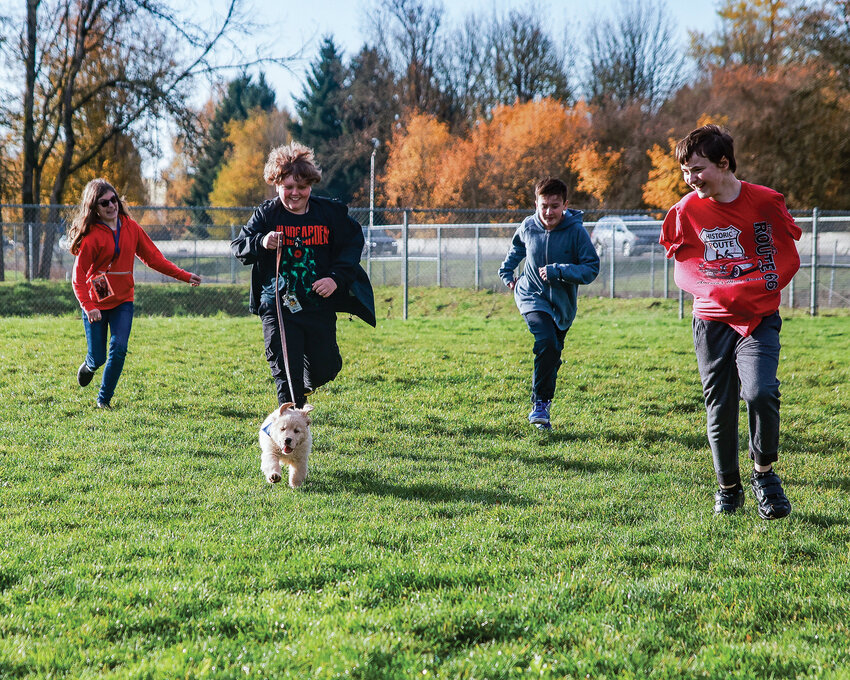 Chief Umtuch students run around with Findley, the school&rsquo;s new therapy dog, during a break from class on Thursday, Nov. 16. From left to right: Emma Stickler, Taven Urban, Connor Wray, Jace Schreiber.