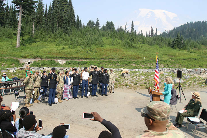 Anne Corsano, U.S. Citizenship and Immigration Services District 20 director, administers to oath of allegiance to new American citizens during a naturalization ceremony at Paradise in Mount Rainier National Park in 2019.