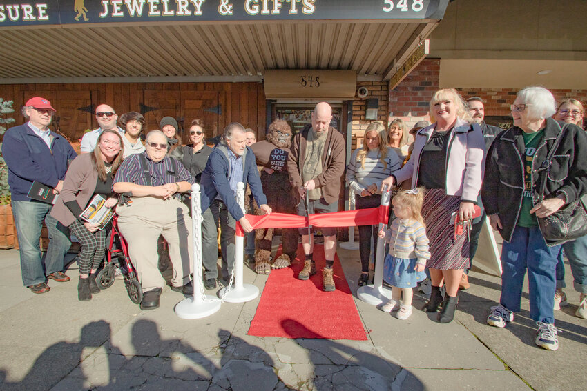 Bigfoot Treasure owner Mitch Moberg officially cuts the ribbon during a Centralia-Chehalis Chamber of Commerce ceremony for his store in downtown Chehalis on Nov. 14.