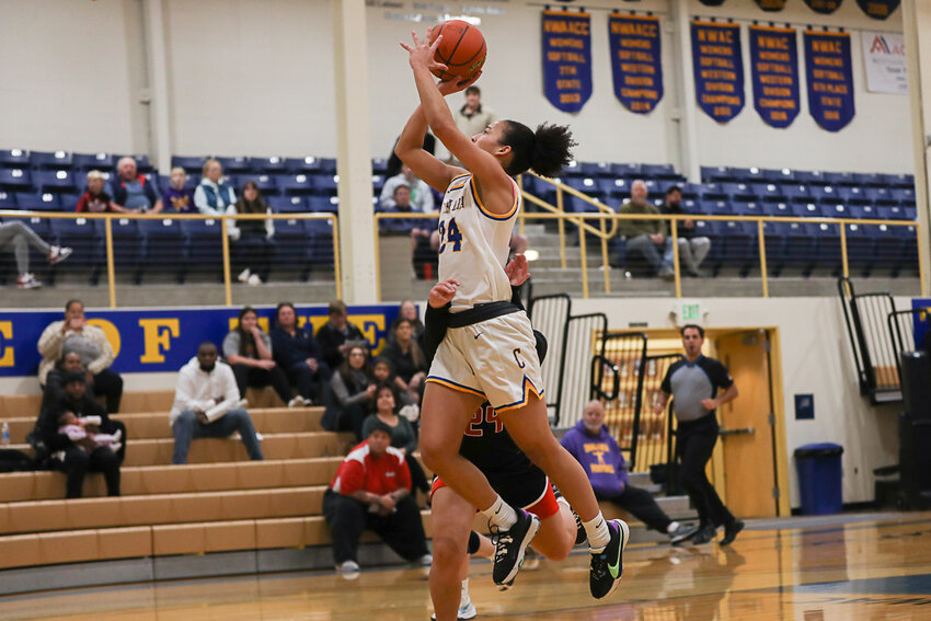 Madison Gore goes up through contact to the hoop during the first half of CC's game against Olympic College, Nov. 28 at Michael Smith Gymnasium.