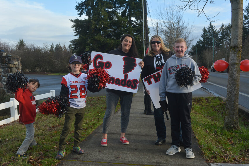 Yelm Tornados fans gather outside Yelm High School with pompoms and signs on Dec. 1.
