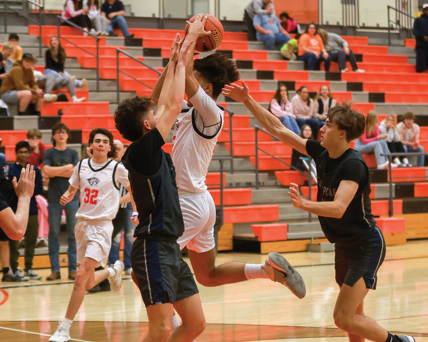 Battle Ground's Austin Ralphs lays it in with two hands in the Tigers&rsquo; third game of the week on Friday, Dec. 1. The Tigers lost, 69-36, to Glacier Peak High School.