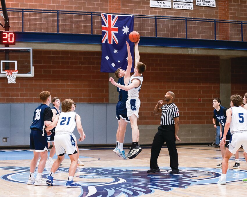 The Australian flag hangs in the background as the opening tip-off gets the game underway between the Hockinson Hawks and the Tenison Woods Titans from Mount Gambier, Australia, on Thursday, Nov. 30.