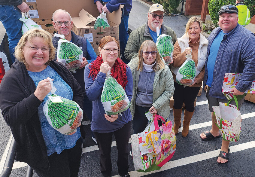 Members of the Ridgefield Lions stand with turkeys they donated to families in need this holiday season. The Lions raised $5,500, which was used to buy food for 110 boxes for families.