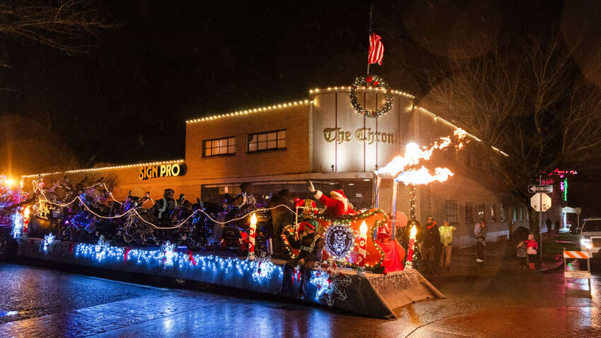 The Centralia Lighted Tractor parade rolls by The Chronicle on North Pearl Street in Centralia on Saturday, Dec. 9.