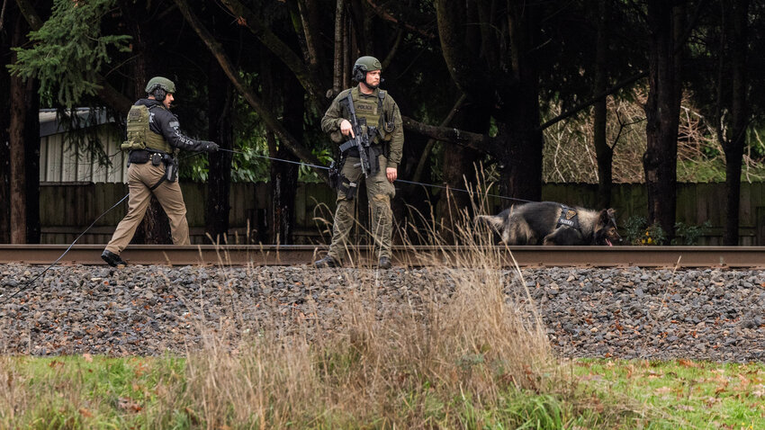 A K9 unit is deployed in Centralia after an armed robbery at the Lewis County Coffee Co. stand along South Tower Ave. in Centralia on Monday, Dec. 11.