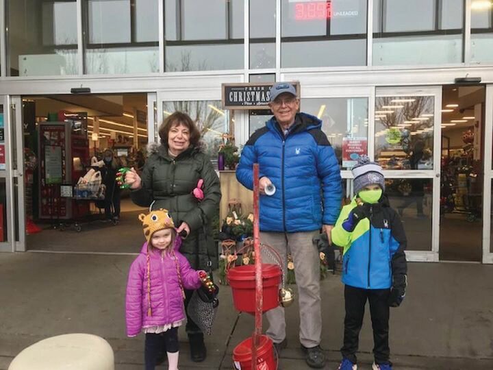 Community members ring bells next to the Salvation Army station outside Yelm Safeway.