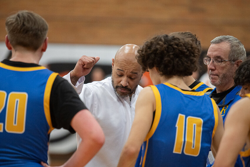 Warrior Coach Gino McDuffy breaks a huddle during a 66-35 Centralia win over Rochester Dec.13.