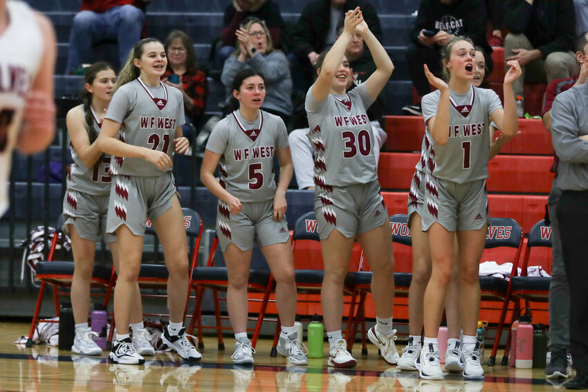 The W.F. West bench celebrates after a 3-pointer during the Bearcats' win at Black Hills on Dec. 14.