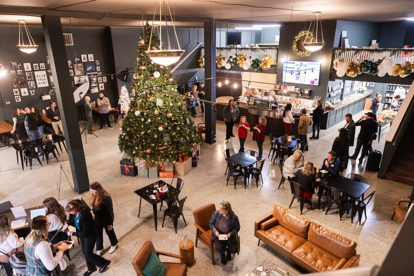 Attendees gather for a Festival of Trees event presented by the Lewis County Young Professionals and Lewis County Coffee Company at The Station in Centralia on Thursday, Dec. 14. Money from each tree will go toward the non-profit that donated them for the event.