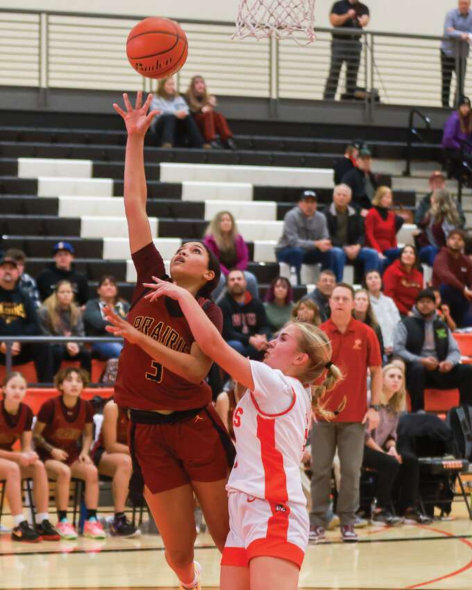 Prairie&rsquo;s Harmony Fallin goes for a layup with Battle Ground&rsquo;s Marissa Loveall closely defending during the Falcons&rsquo; 68-33 win against the Tigers on Wednesday, Dec. 13.