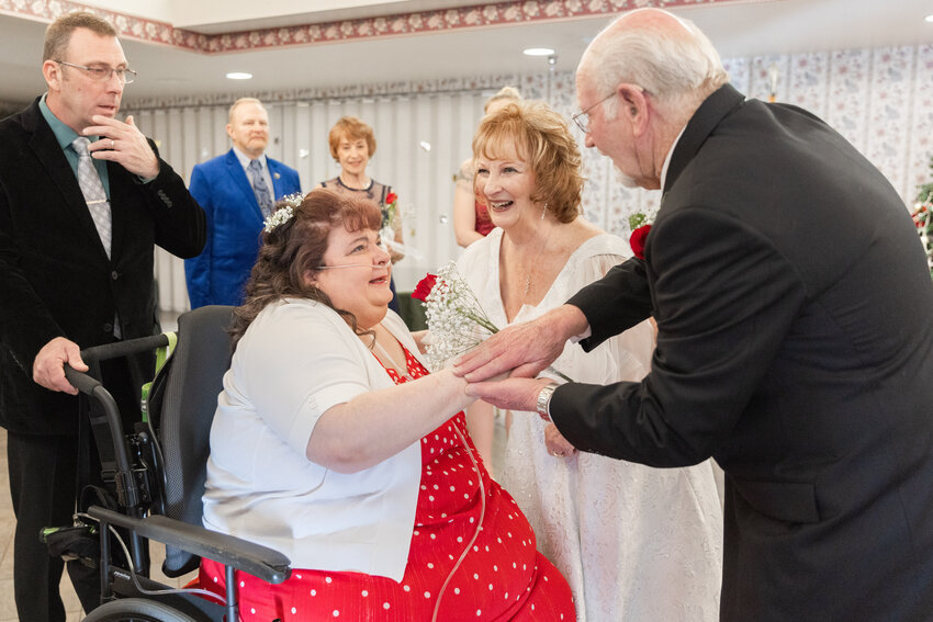 Sue and Gary Van Dyken, 73 and 78, smile as they greet their daughter Lori McNellis, 54, a Sharon Care resident, after a wedding ceremony at the Sharon Care Center in Centralia on Saturday, Dec. 16.