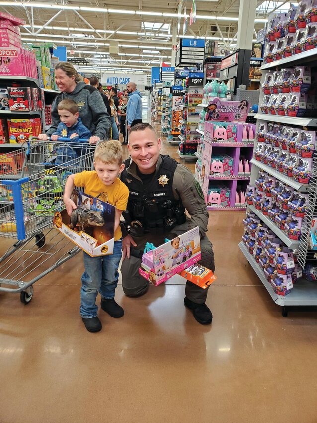 A child shops with a cop at Walmart in Yelm on Dec. 13.