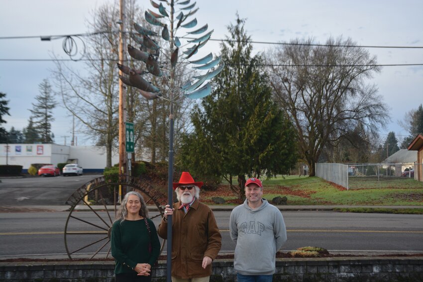 Heidi Haslinger, Steve Craig and Steve Harshfield, Yelm arts commissioners, smile for a photo on Dec. 12 after a wind sculpture was unveiled.