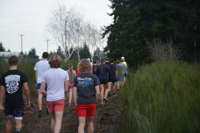 Members of Yelm's track and field team walk about their newly built trail on Wednesday, Dec. 13.