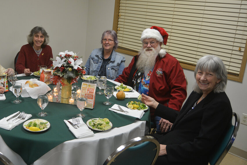 Attendees, including Harry Miller as Santa Claus, enjoy a salad at the Yelm Senior Center Winter Social &amp; Auction on Dec. 16.