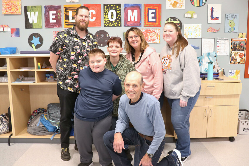 From left, Michael Smith, John Allison, Angela Mason, Paul Avery, Kris Tokstad and Mackenzie Wasson smile for a photo in the special education classroom at Fords Prairie Elementary School in Centralia.