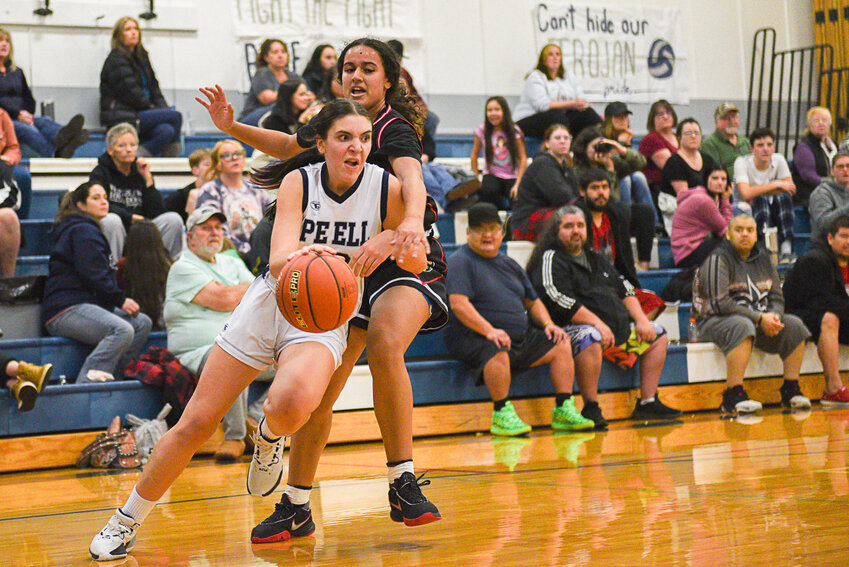 Pe Ell's Emma Kissner drives past Oakville's Alyssa Forsythe during the first half of the Trojans' 48-31 win over the Acorns on Dec. 20.