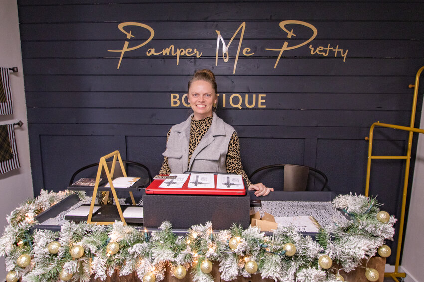 Pamper Me Pretty Boutique owner Misty Daily poses on Tuesday, Dec. 19, behind the counter of her new business she opened last month in Chehalis.