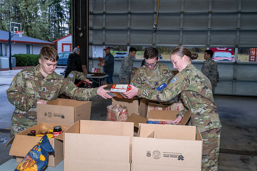 Battle Ground High School Air Force Junior Reserve Officer Training Corps cadets at the Dollar Corner fire station help sort through 15,707 pounds of perishable food items collected in Battle Ground from the Dec. 2 Walk &amp; Knock event. The Clark County Food Bank more than 265,000 total pounds of items.