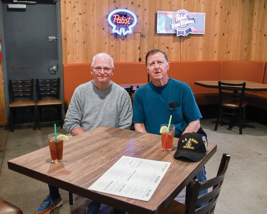 Battle Ground mayor and veteran Philip Johnson, left, along with veteran James Huber, enjoy a veterans luncheon at Prairie Tavern on June 16.