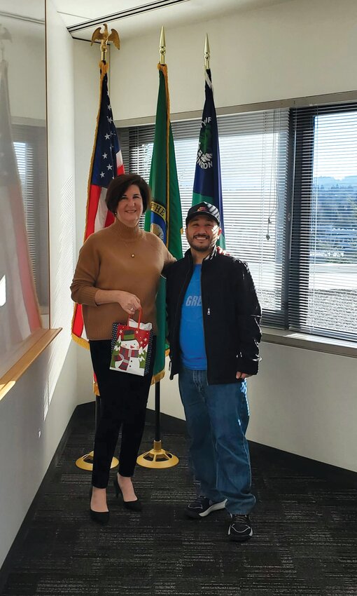 Yelm Mayor Joe DePinto meets with Bellevue Mayor Lynne Robinson on Wednesday, Dec. 20 to deliver meats from Stewart's Meat Market.