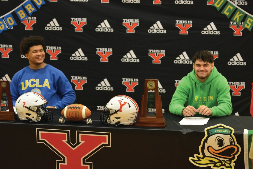 UCLA-bound Isaiah Patterson and Oregon-bound Brayden Platt smile prior to each signing his National Letter of Intent on Dec. 20 inside of YHS&rsquo;s gymnasium.