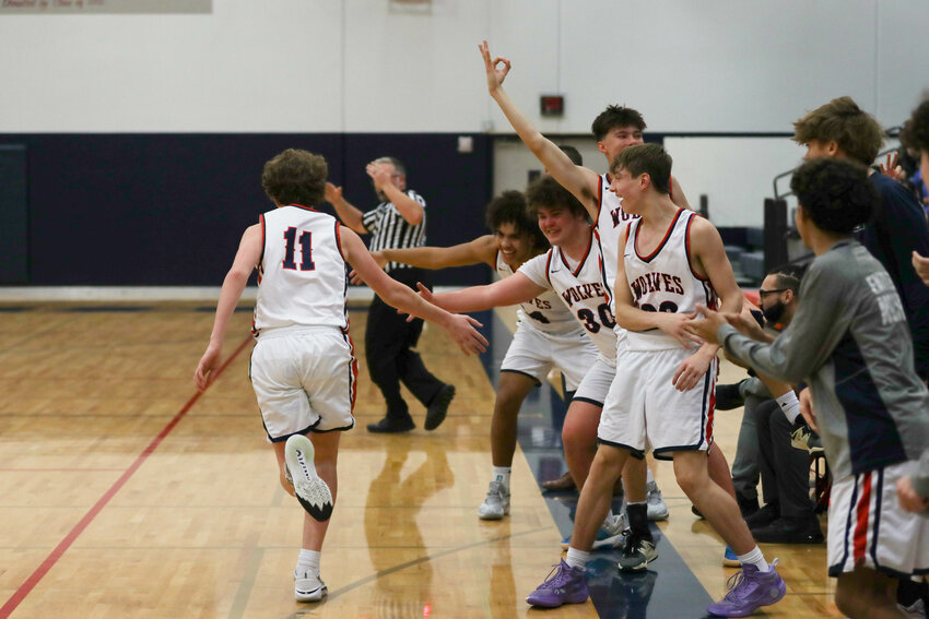 Peyton Faught high fives the Black Hills bench after hitting a three during Black Hills' win over Rochester on Jan. 2.