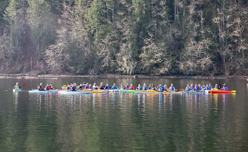 Roughly 40 kayakers smile for a photo before heading out for a guided tour of Lake Mayfield on Monday, Jan. 1.