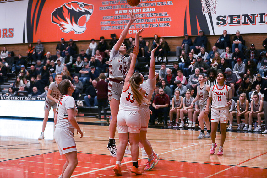 Julia Dalan leaps over two defenders for a bucket during W.F. West's win at Centralia on Jan. 5.
