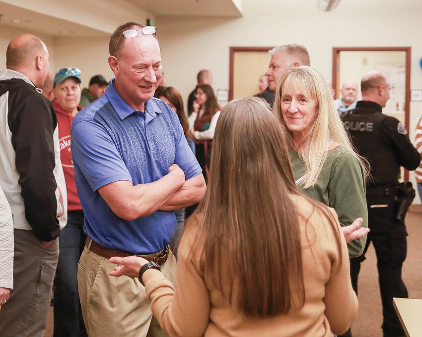 Former Battle Ground Police Chief Mike Fort, left, speaks with visitors at his retirement party on Tuesday, Jan. 2 at the Battle Ground Police Station.