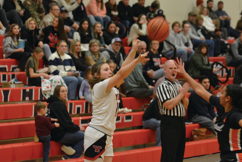 Junior Emma Weiser fires off a 3-point shot with a defender in her face on Friday, Jan. 5.